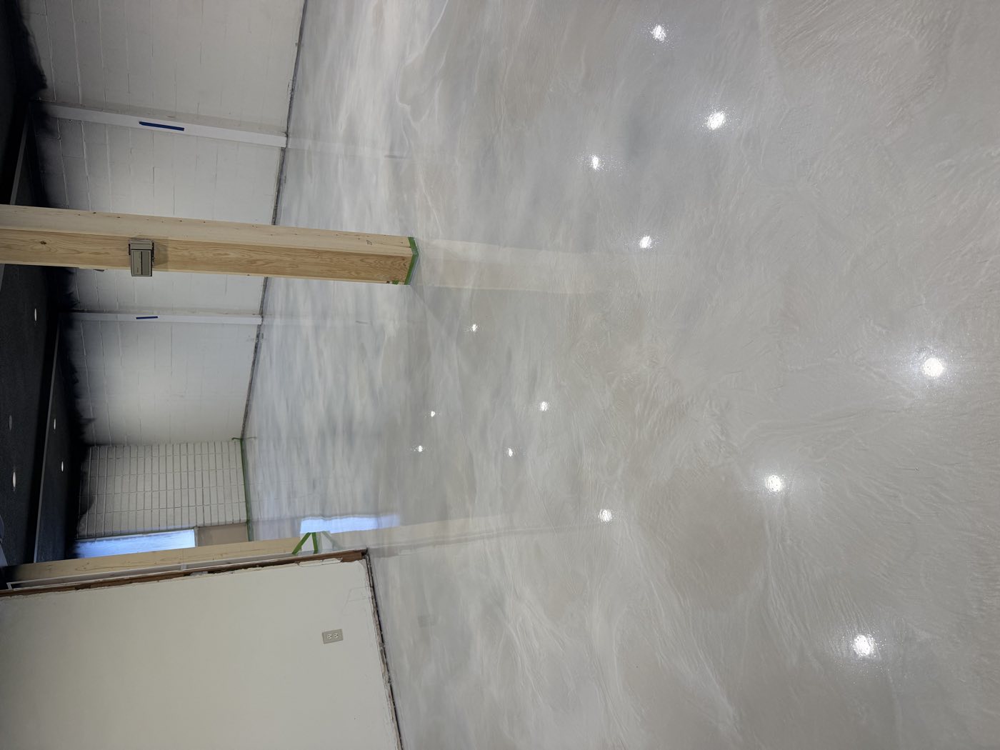 Glossy snow-white metallic epoxy floor after SeaWolf Coatings install